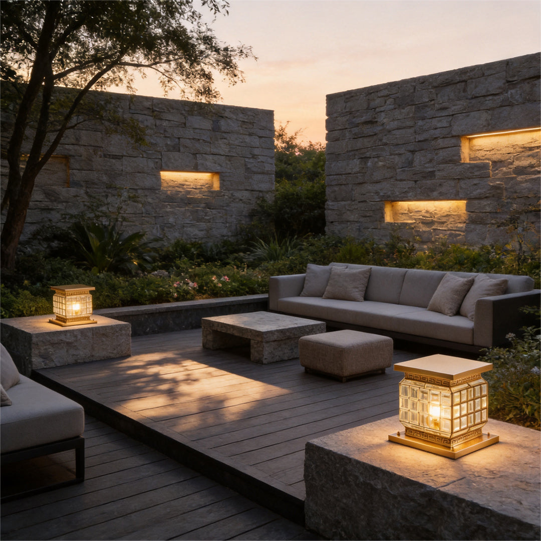 Decorative outdoor pillar lights solar placed around contemporary patio seating area at sunset.