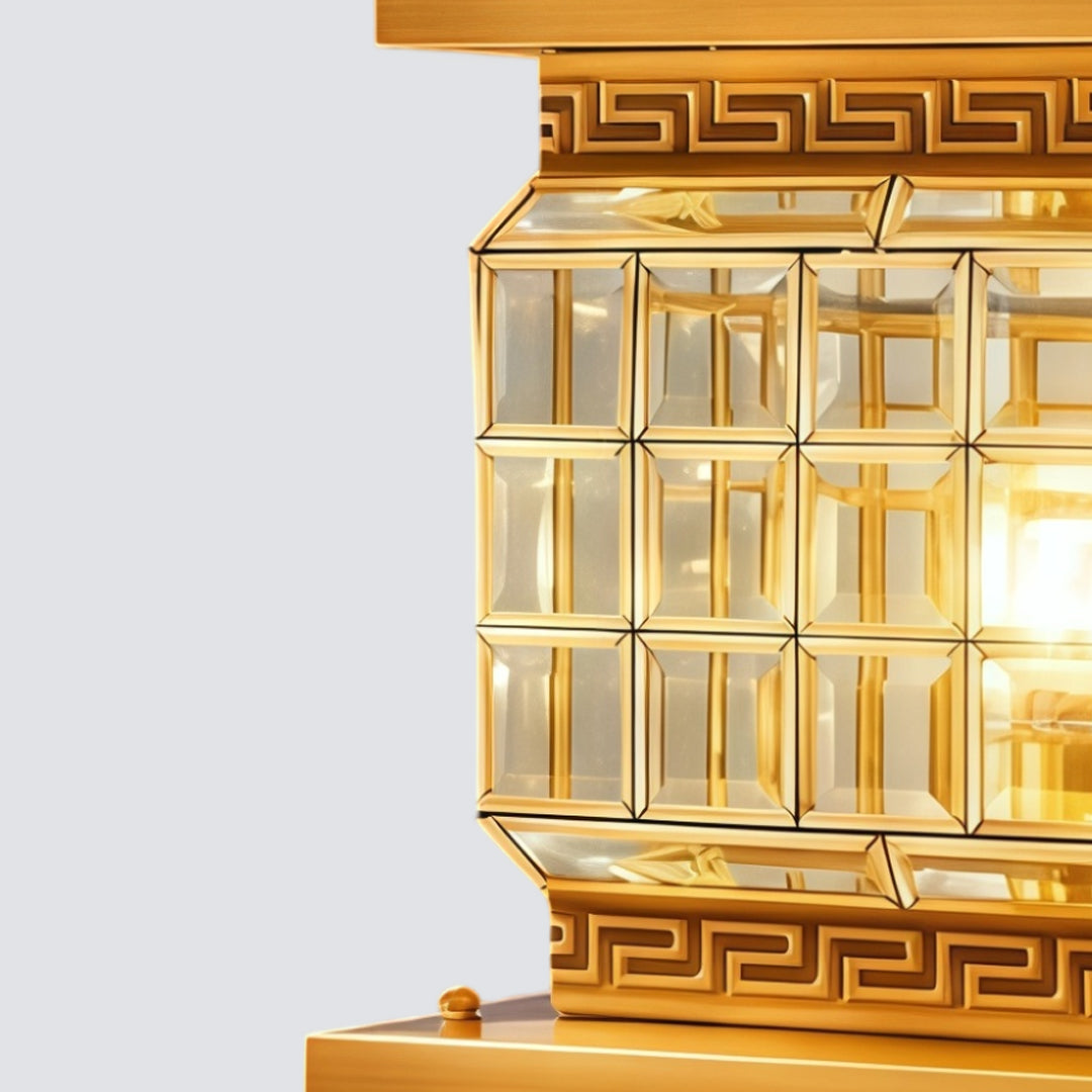 Close-up of gold outdoor pillar lights solar with geometric glass detailing and warm LED light.