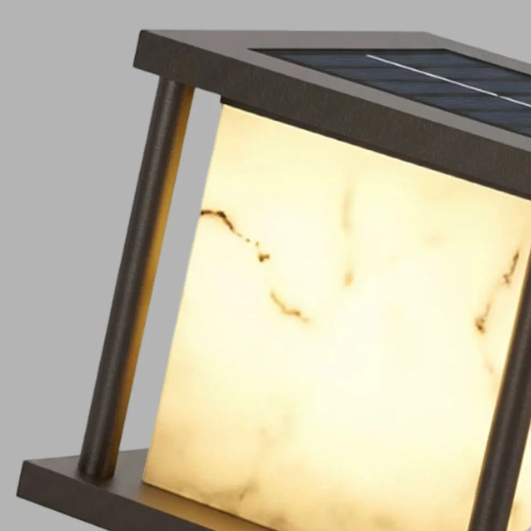 Close-up of outdoor pillar solar lights showing the integrated solar panel on the top surface.