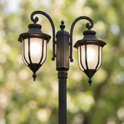 Outdoor post light fixture close-up featuring twin lantern heads and a black decorative pole.