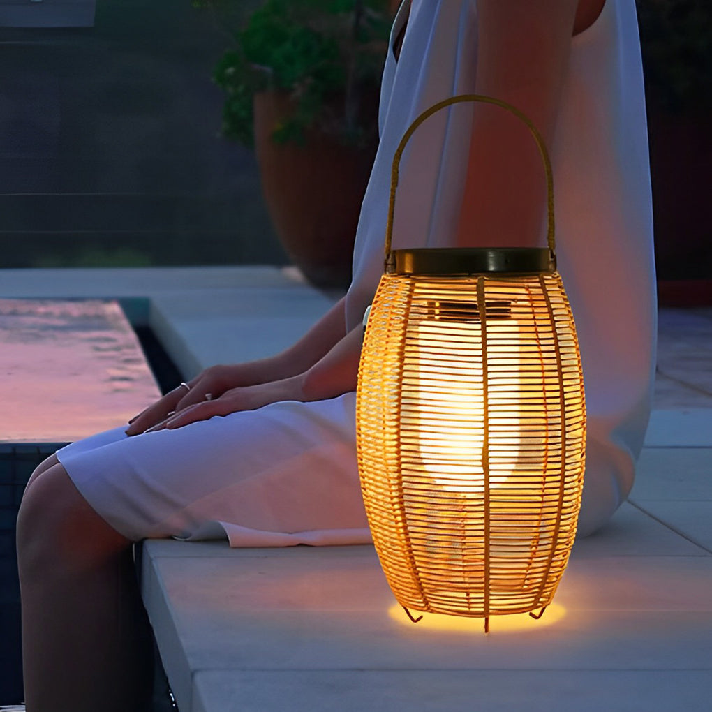Outdoor rattan lanterns illuminating garden pathway with warm glow.