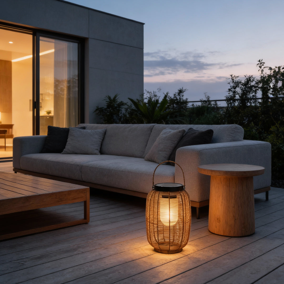 Outdoor rattan lanterns placed beside modern outdoor sofa with soft lighting.
