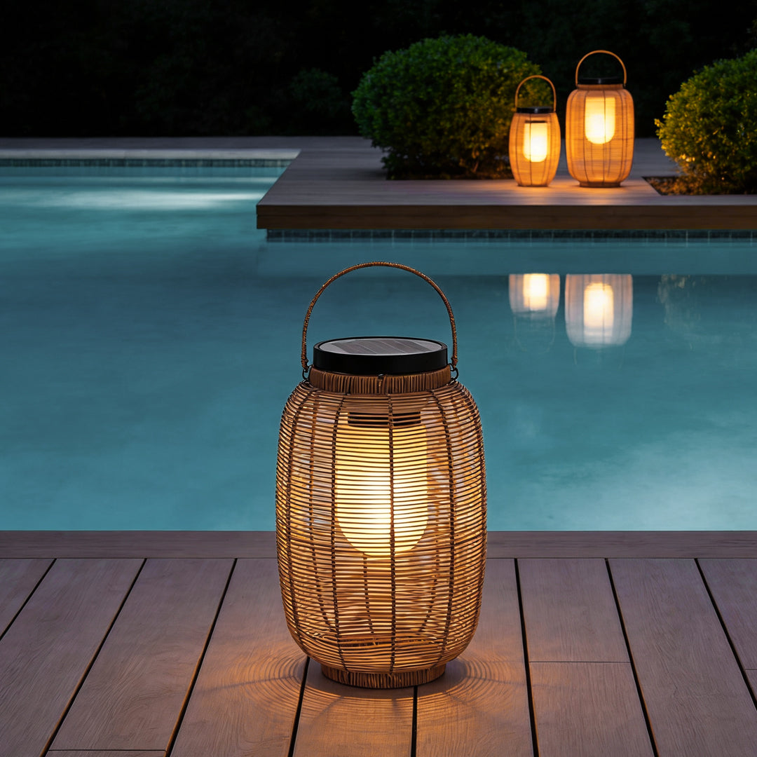 Outdoor rattan lanterns illuminating poolside deck with warm glow at dusk.