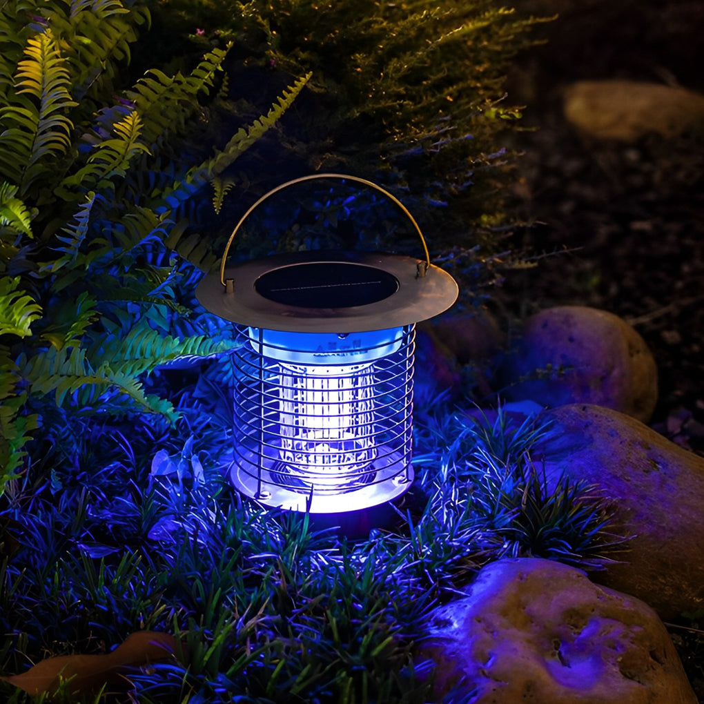 Outdoor solar light bug zapper lamp placed among plants, showing mosquito control lighting effect.