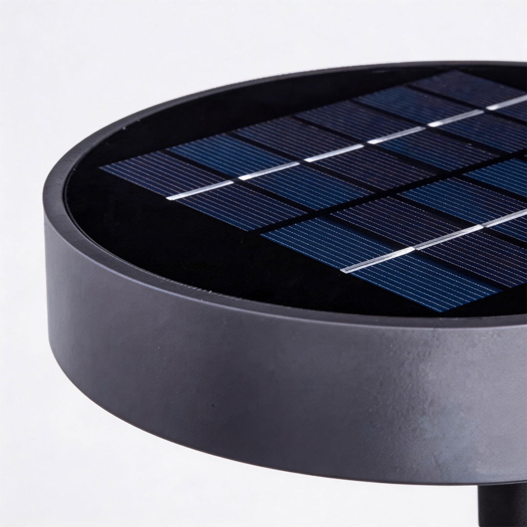 Close-up of outdoor solar lighting wall mount showcasing its solar panel and warm light.