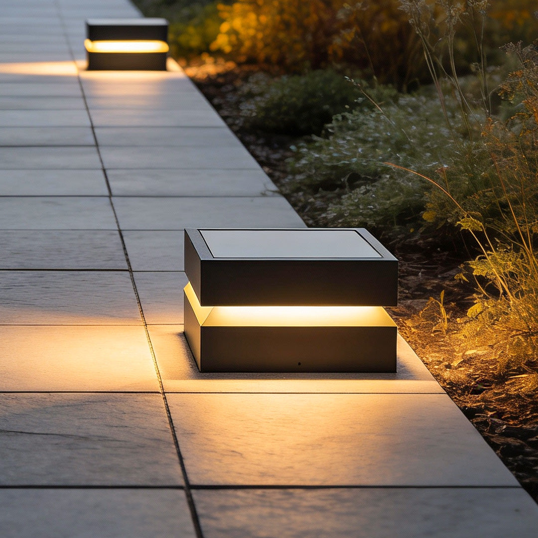 Outdoor solar lights deck with layered design, illuminating stone pathway at dusk.