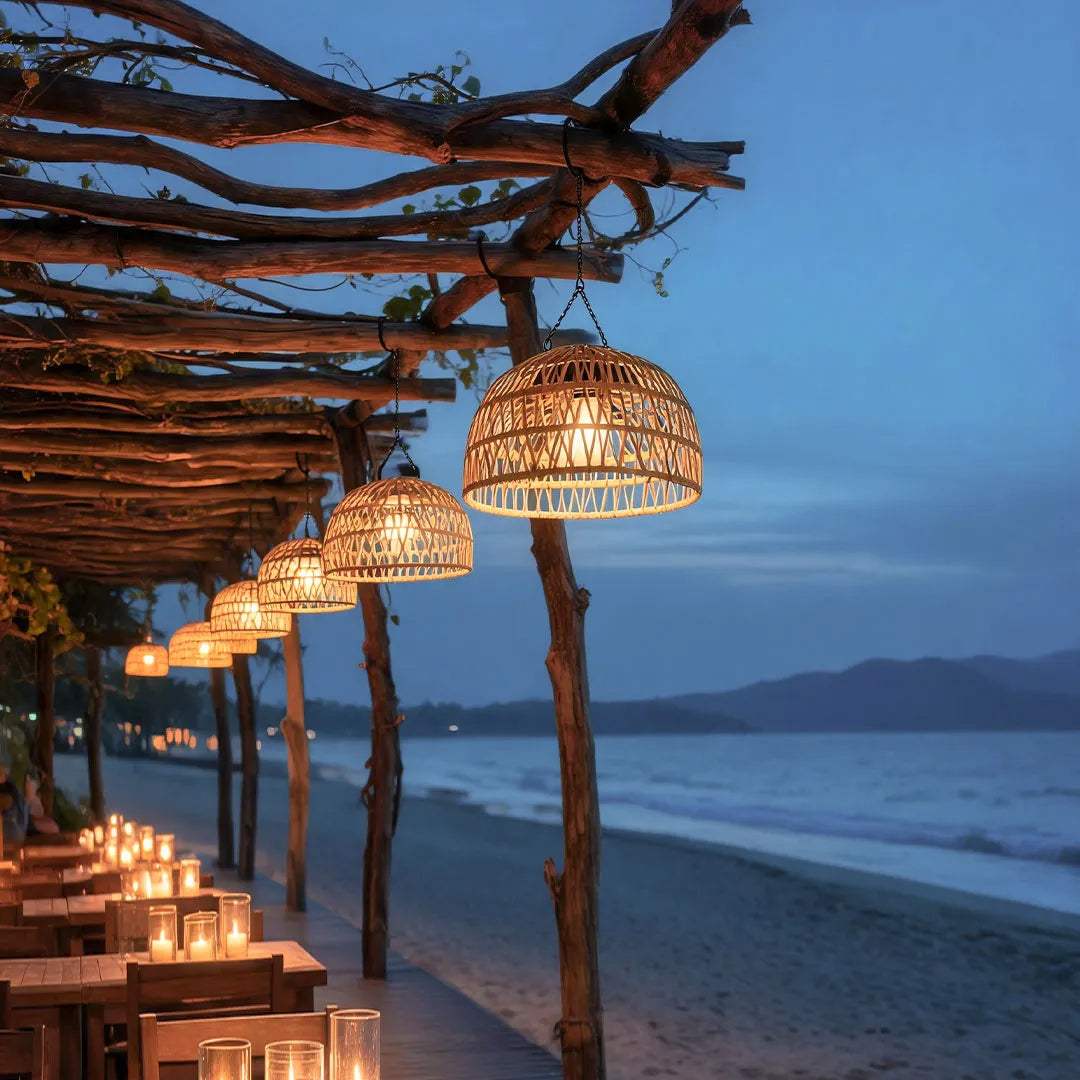 Outdoor solar pendant light installed along a beachside pergola creating warm decorative lighting.