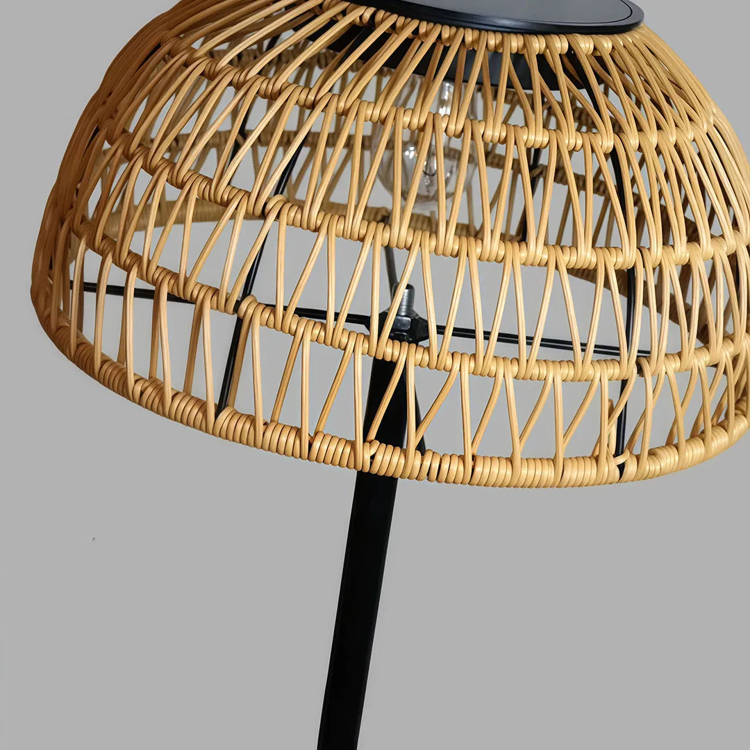 Outdoor solar pendant light close-up showing the woven rattan shade and integrated solar panel.