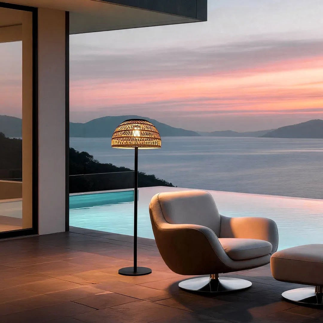 Outdoor solar pendant light illuminating a modern outdoor lounge area with a natural woven design.