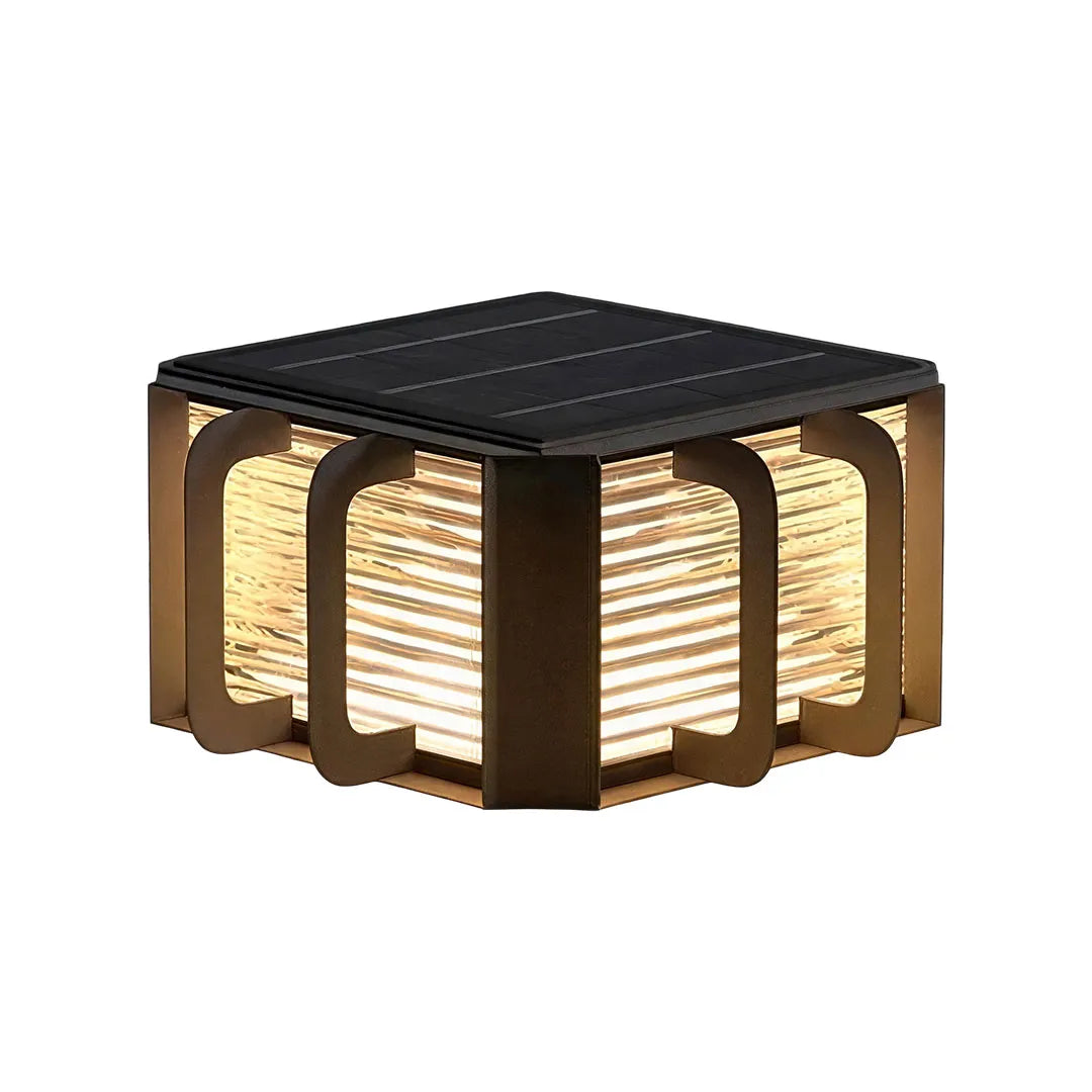 Outdoor solar pillar lights installed along a landscaped garden border with warm accent lighting.