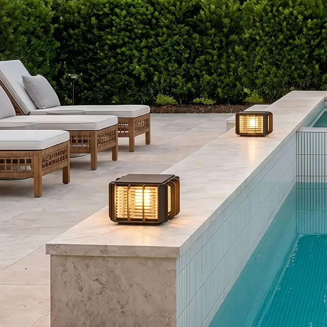 Outdoor solar pillar lights mounted on entrance gate columns creating warm exterior lighting.