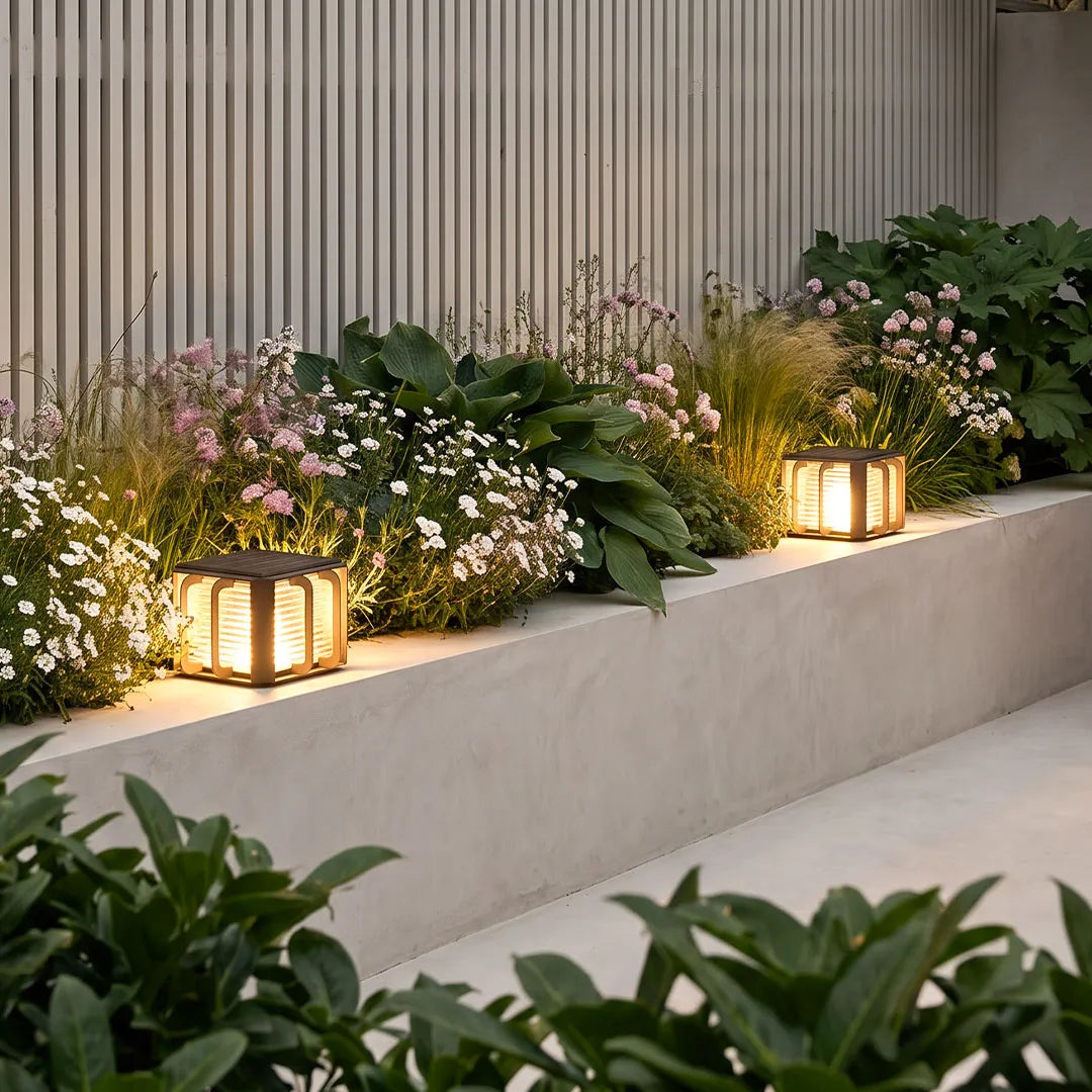 Outdoor solar pillar lights illuminating a poolside patio with elegant landscape lighting.