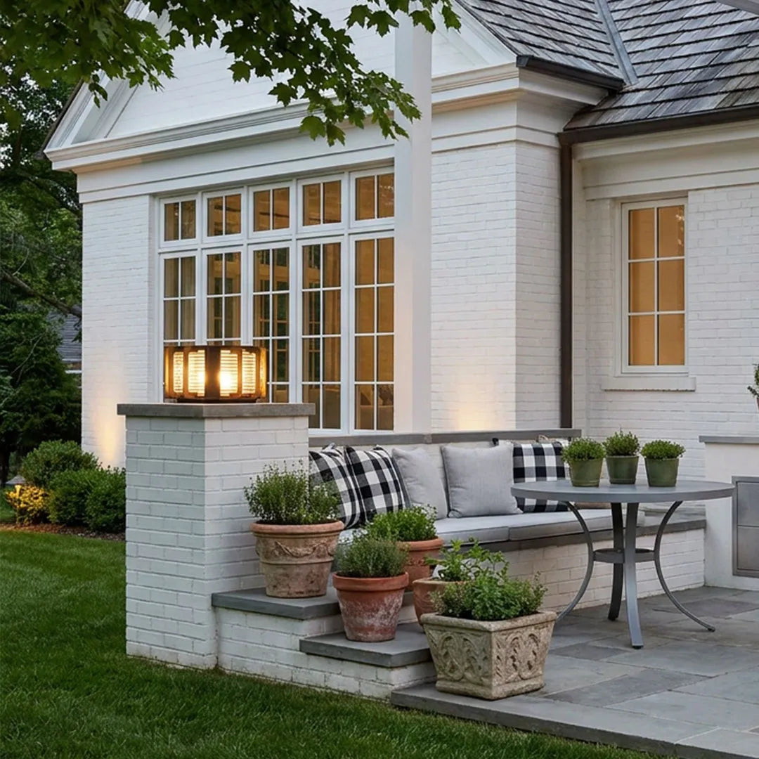 Outdoor solar pillar lights installed on residential gate columns enhancing the home's exterior.