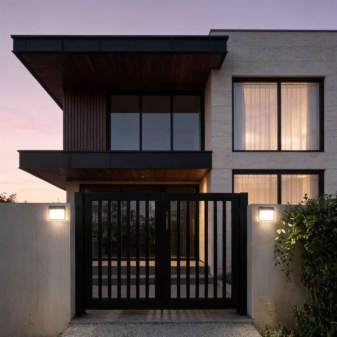 Outdoor solar wall light with motion sensor providing soft illumination beside a stylish entrance.