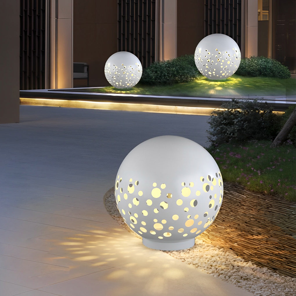 Outdoor sphere light with a close-up of its perforated pattern and warm glow.