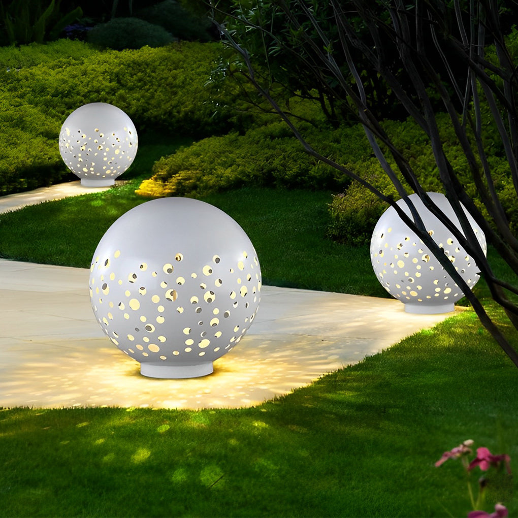 Outdoor sphere light with a white finish, providing elegant illumination in a garden.