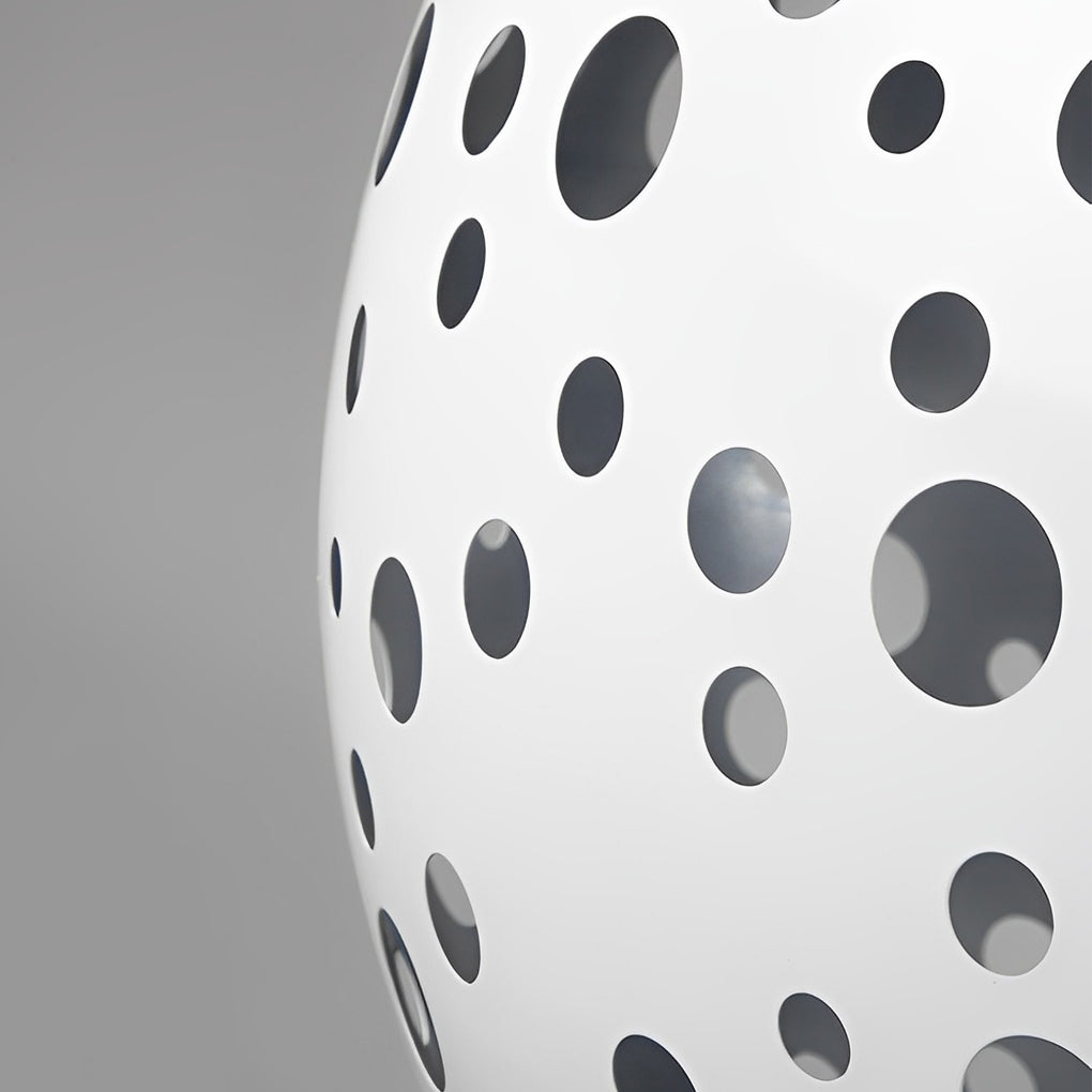 Outdoor sphere light with a white finish, providing soft illumination near a patio.