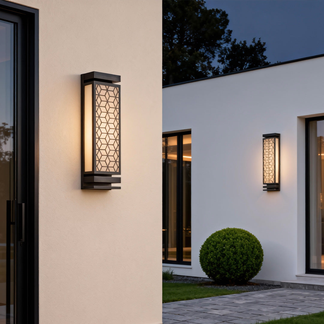 Outdoor square wall sconce light mounted on a modern house exterior, providing warm and inviting illumination.