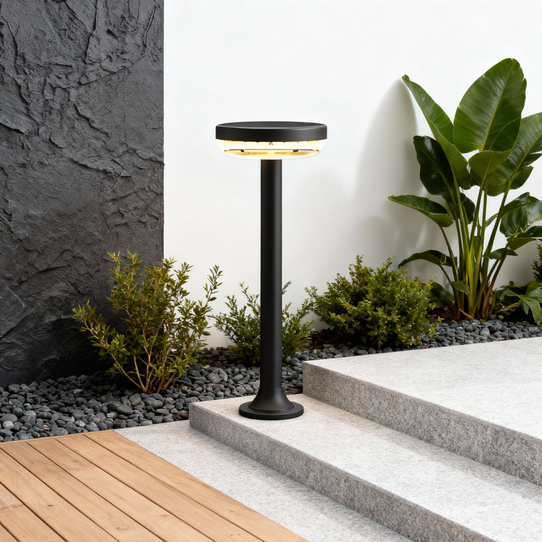 Path light solar fixture installed beside outdoor steps providing soft walkway illumination.