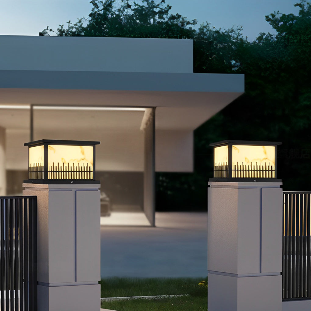 Outdoor stone pillar lights providing ambient light to a contemporary outdoor seating area.