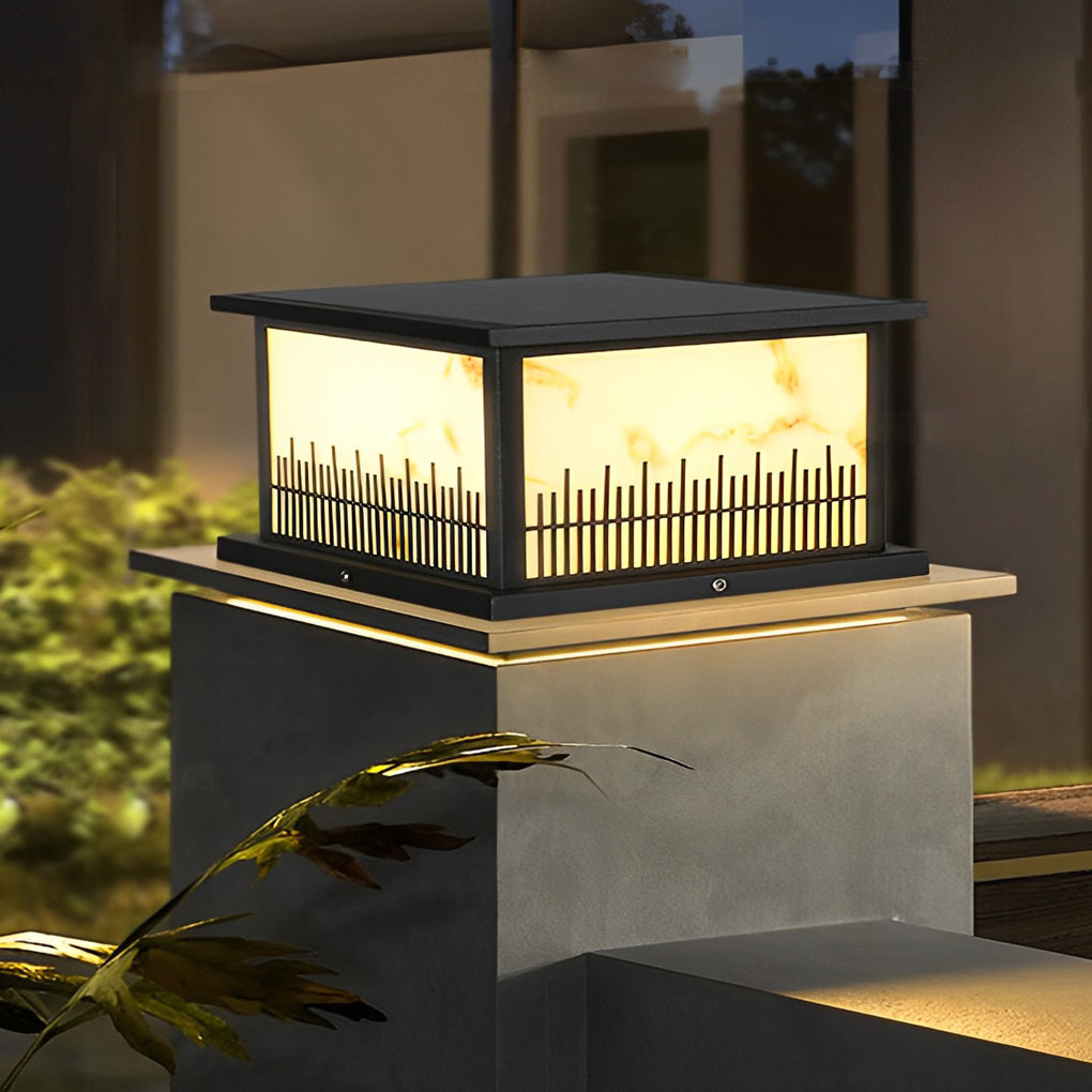 Outdoor stone pillar lights illuminating a garden pathway, creating a welcoming atmosphere.