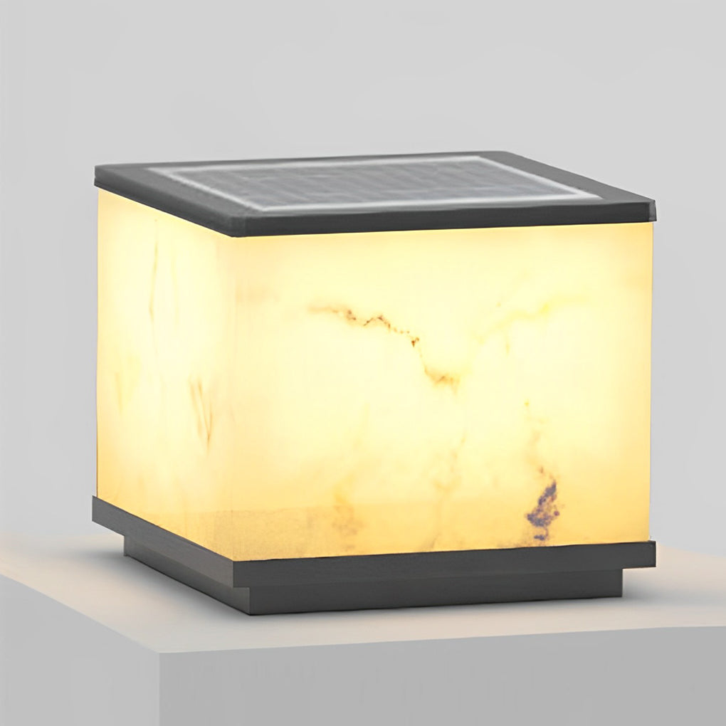 Outdoor stone pillar lights with a modern design, installed near a building with a coastal view.