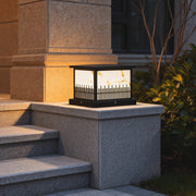 Outdoor stone pillar lights illuminating a set of stone steps, adding elegance to the garden entrance.