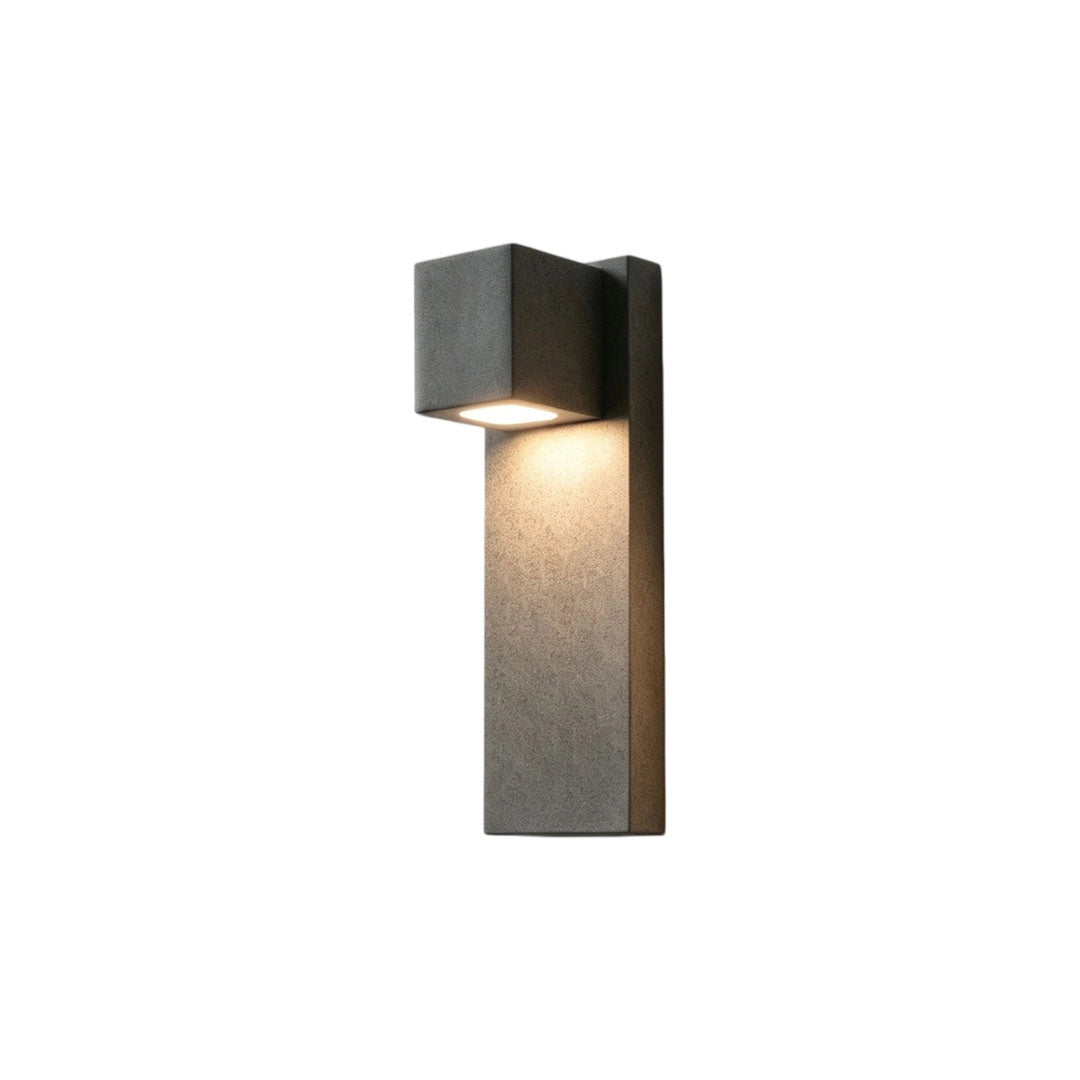 Outdoor stone wall lighting in a dark gray stone finish isolated on a white background.