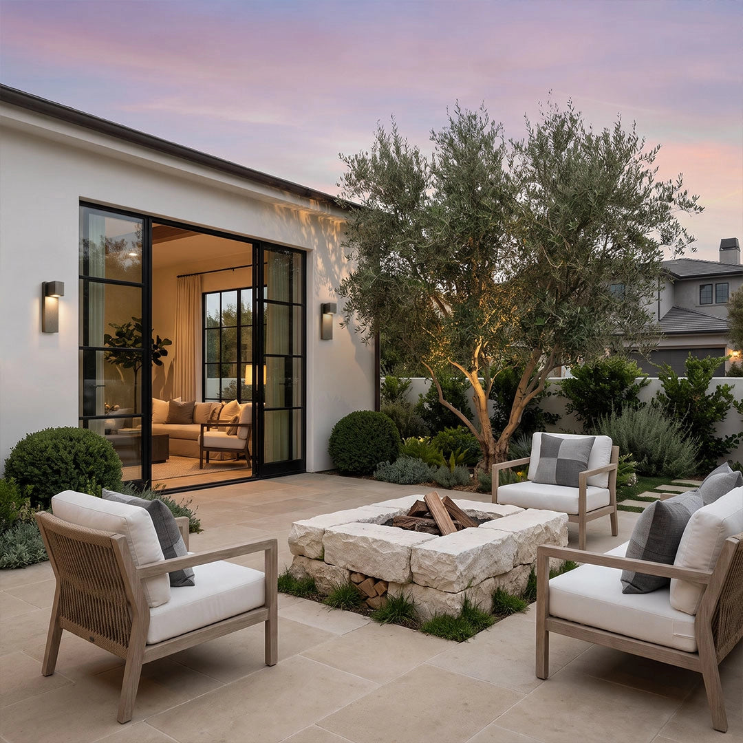 Outdoor stone wall lighting brightening a contemporary patio and outdoor seating area.