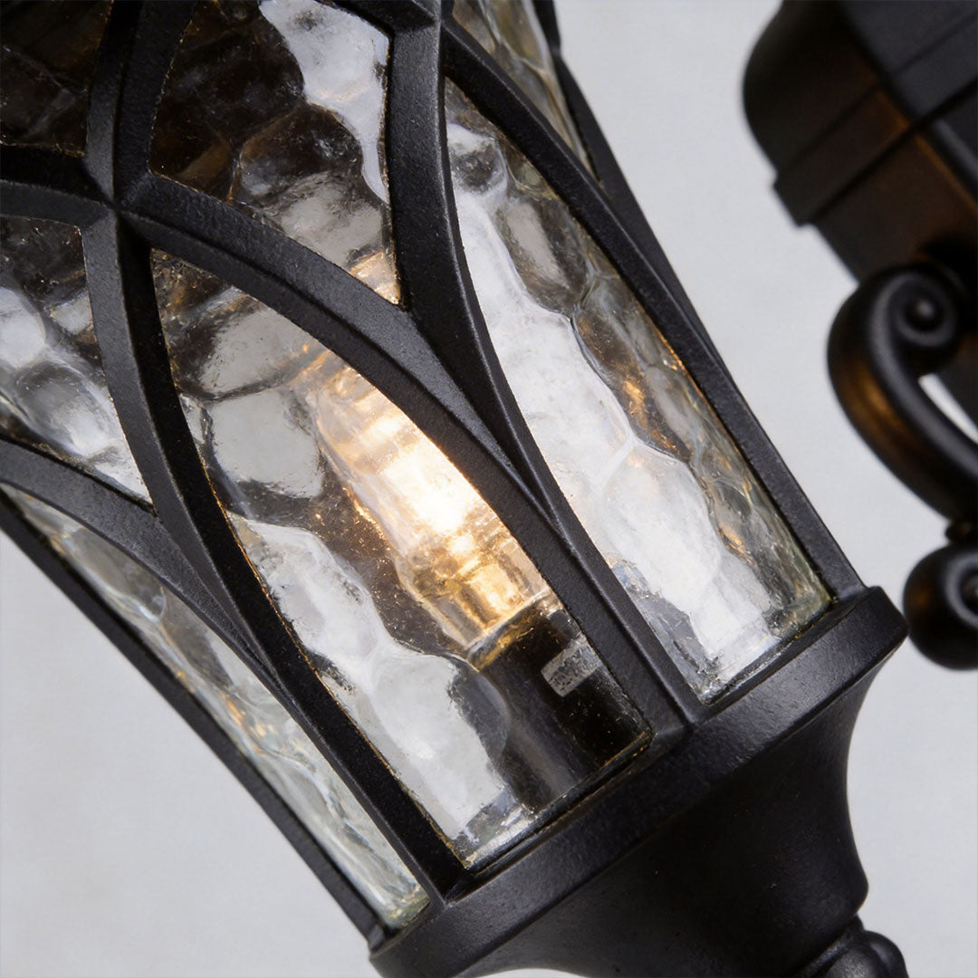 Outdoor street light with a classic design, mounted beside a stone pathway.
