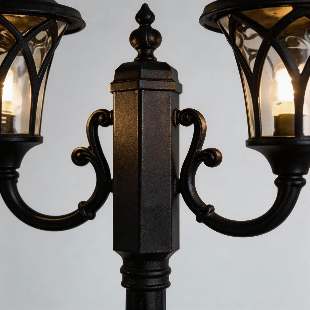 Close-up of outdoor street light showcasing its ornate black design.