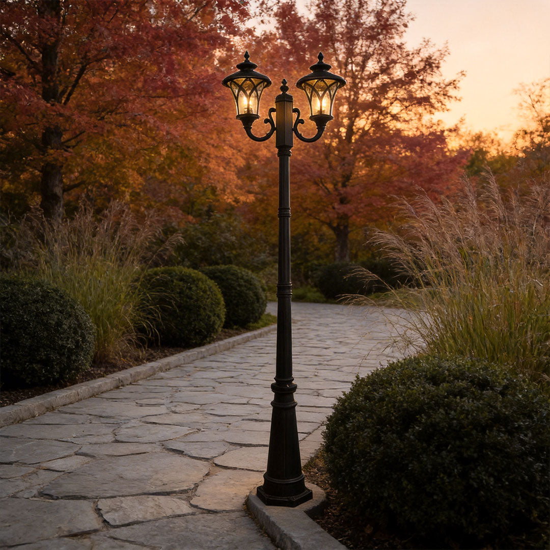 Outdoor street light with a modern design, providing warm illumination near a fence.
