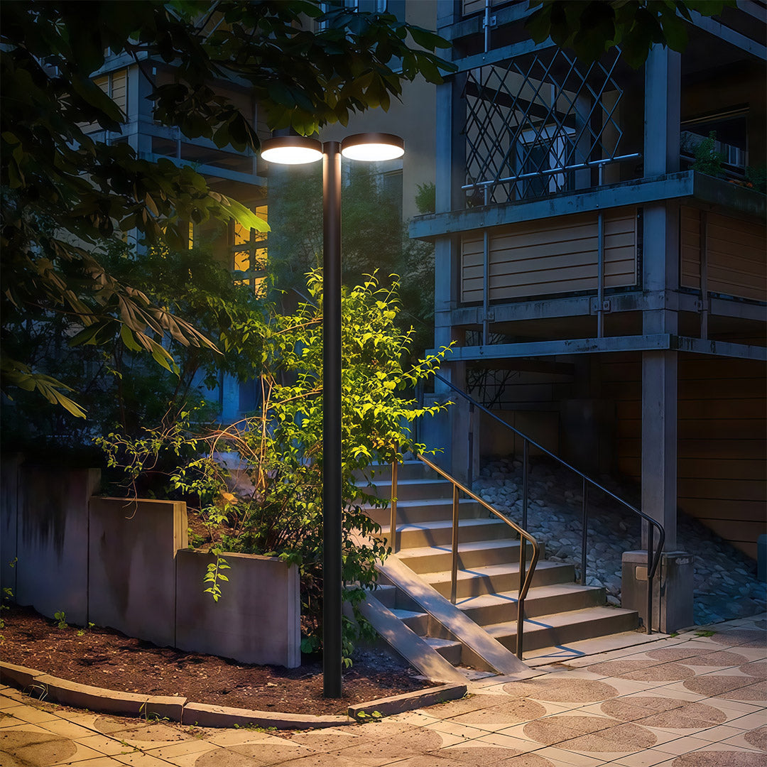 Outdoor street lighting illuminating a quiet residential area with a soft, welcoming glow.