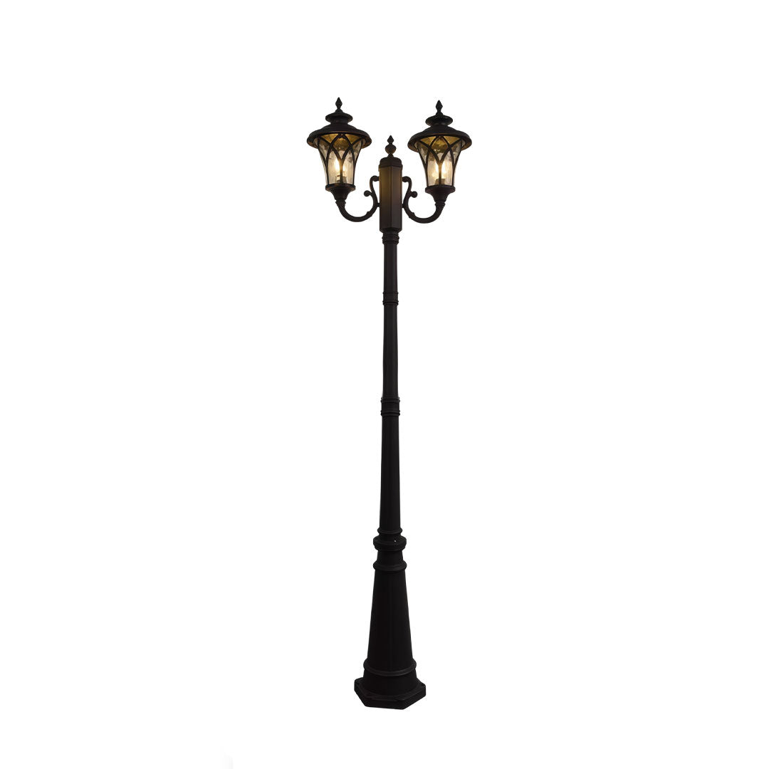 Outdoor street light with a vintage design, illuminating a residential street.