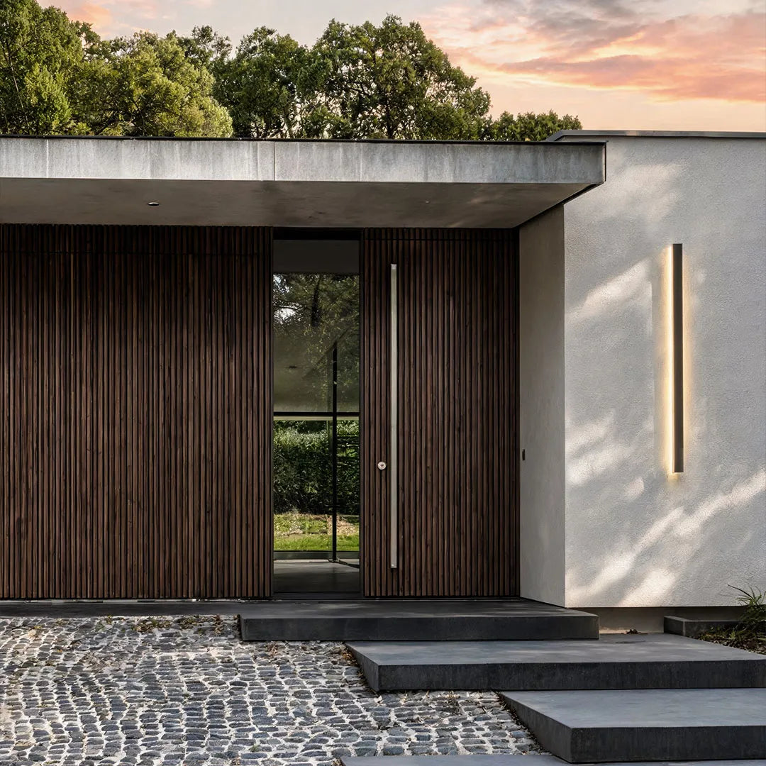 Outdoor strip wall light installed on a modern home entry wall with warm ambient illumination.
