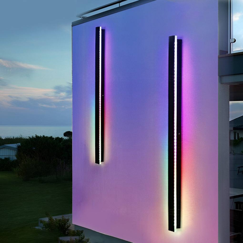 Outdoor strip wall light enhancing a modern house with purple and blue hues.