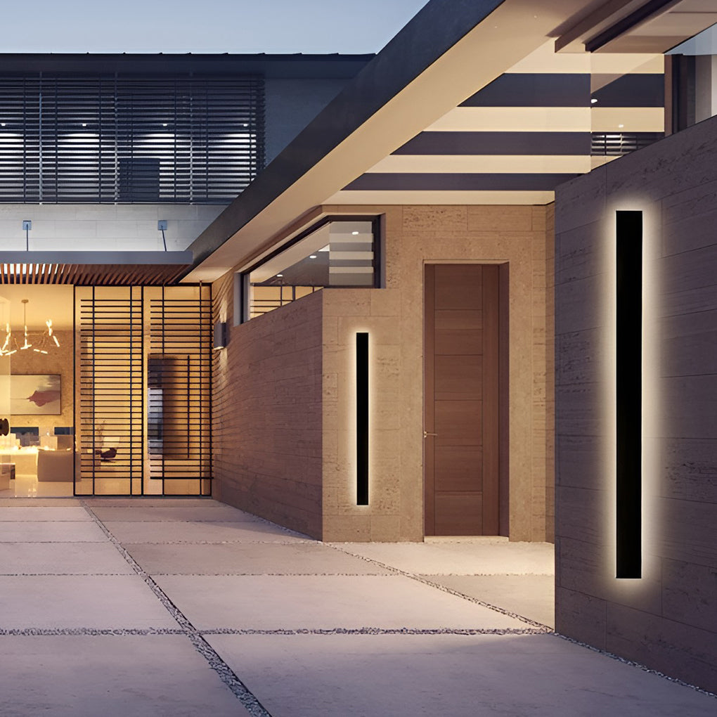 Outdoor strip wall light illuminating a modern outdoor space with minimalist design.