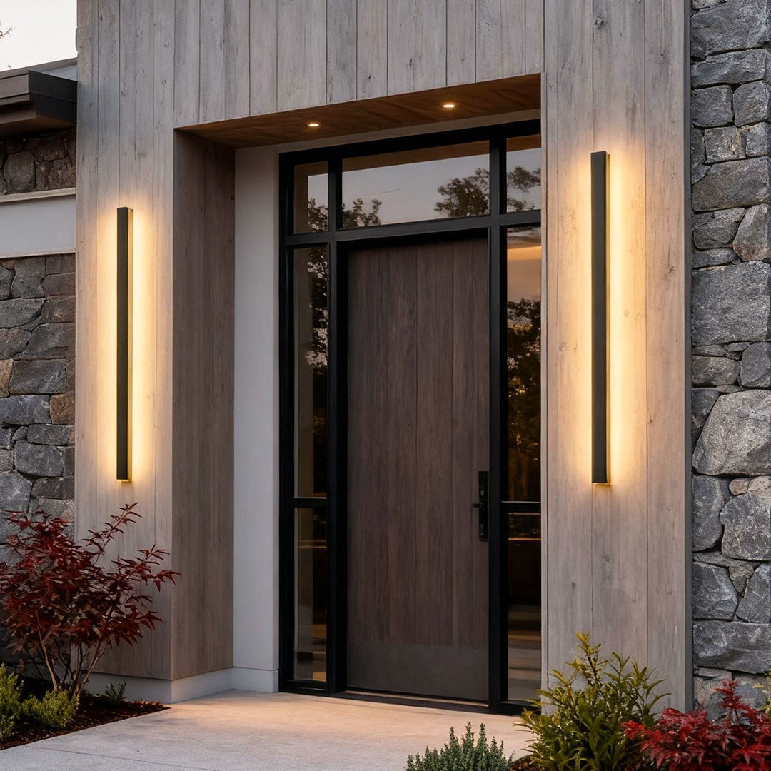 Outdoor strip wall light providing soft linear illumination beside a wooden door.