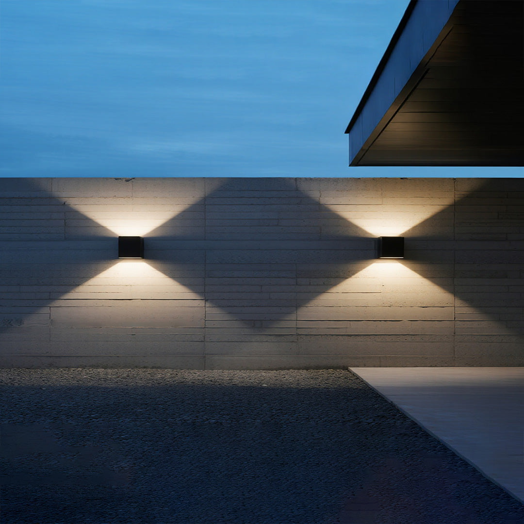 Outdoor up down wall light enhancing a minimalist outdoor space at dusk.