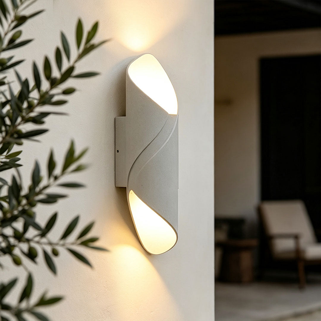 Outdoor up down wall light with a modern curved design mounted on an exterior wall.