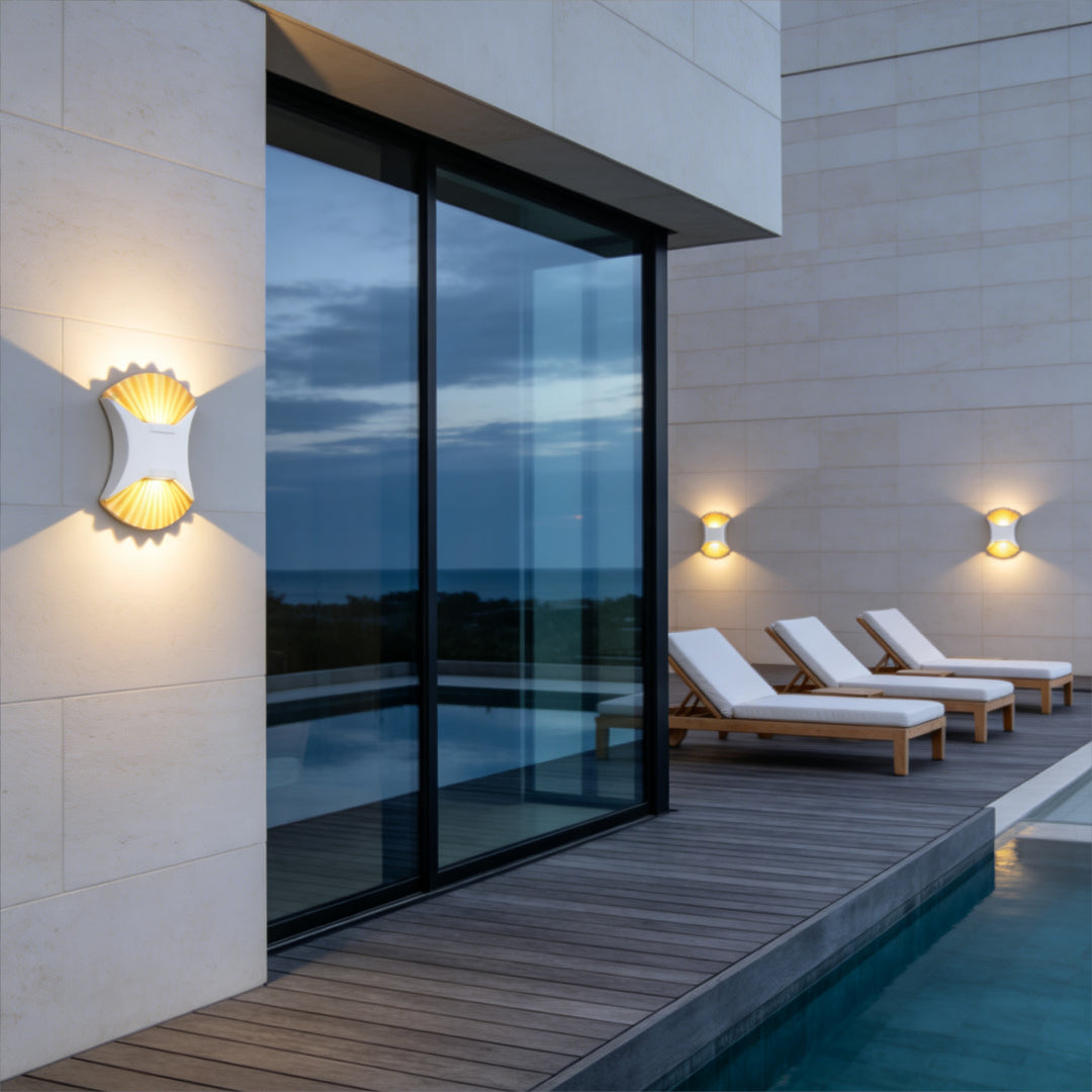 Modern outdoor up down wall light installed beside glass patio wall near swimming pool area.