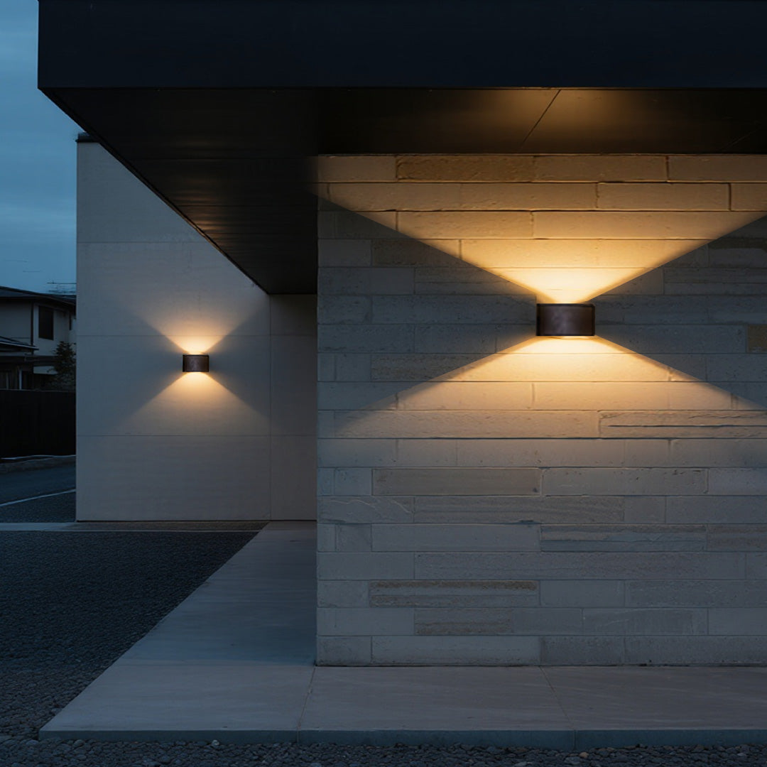 Outdoor up down wall light providing soft illumination on a contemporary exterior wall.
