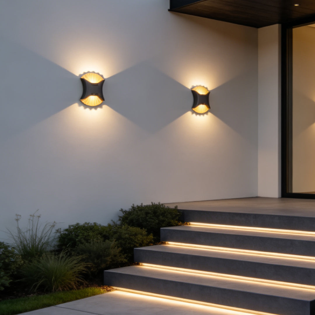 Outdoor up down wall light illuminating modern exterior staircase with geometric light projection.