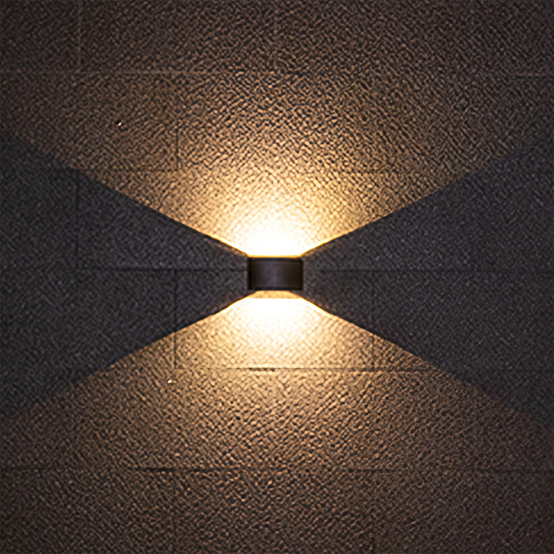 Outdoor up down wall light producing symmetric up and down beams on grey surface