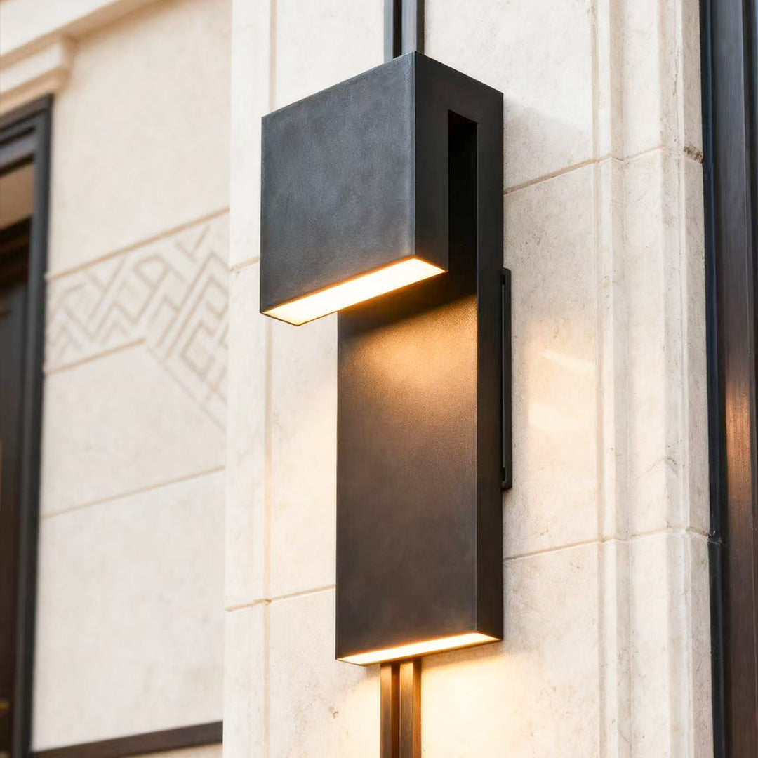 industrial outdoor wall light mounted on stone wall providing warm illumination at entryway