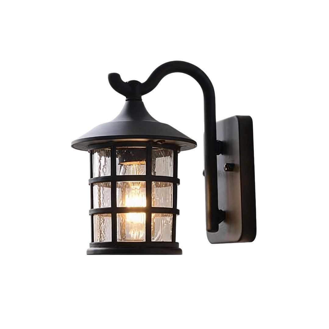 Outdoor wall light lantern in a black finish with a curved arm and seeded glass enclosure.