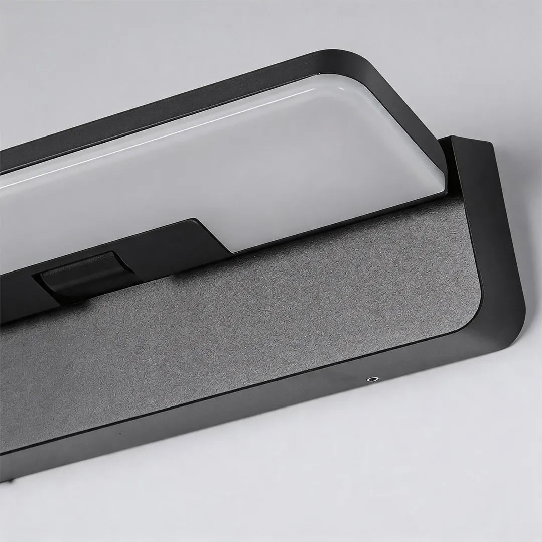 Outdoor wall light with white LED diffuser and black metal frame detail