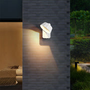Outdoor wall light installation on modern house exterior with warm lighting at evening