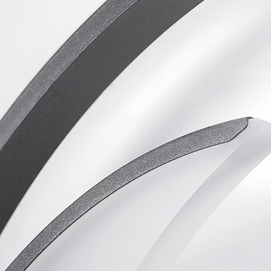 Close-up detail of decorative outdoor wall lights showing textured finish and curved design