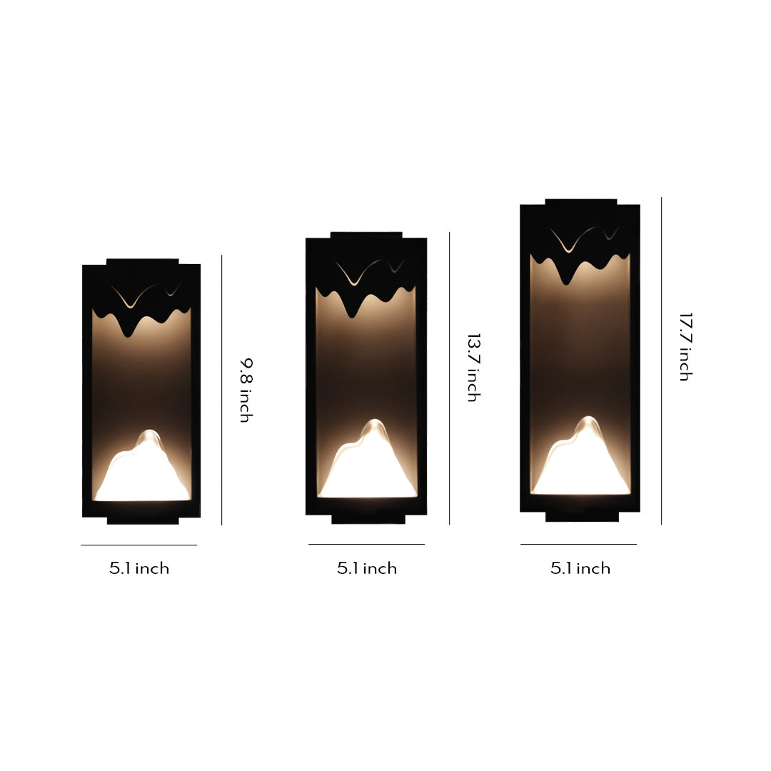 Outdoor wall lighting ideas showcasing three sizes of modern sconces with black finish and geometric cutout designs